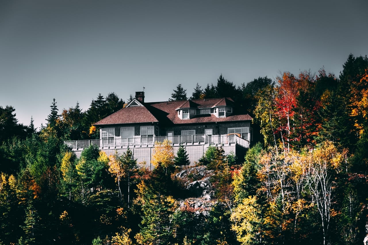 house-on-hill-with-fall-trees