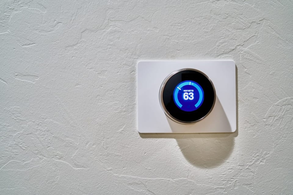 digital thermostat set at 63 degrees